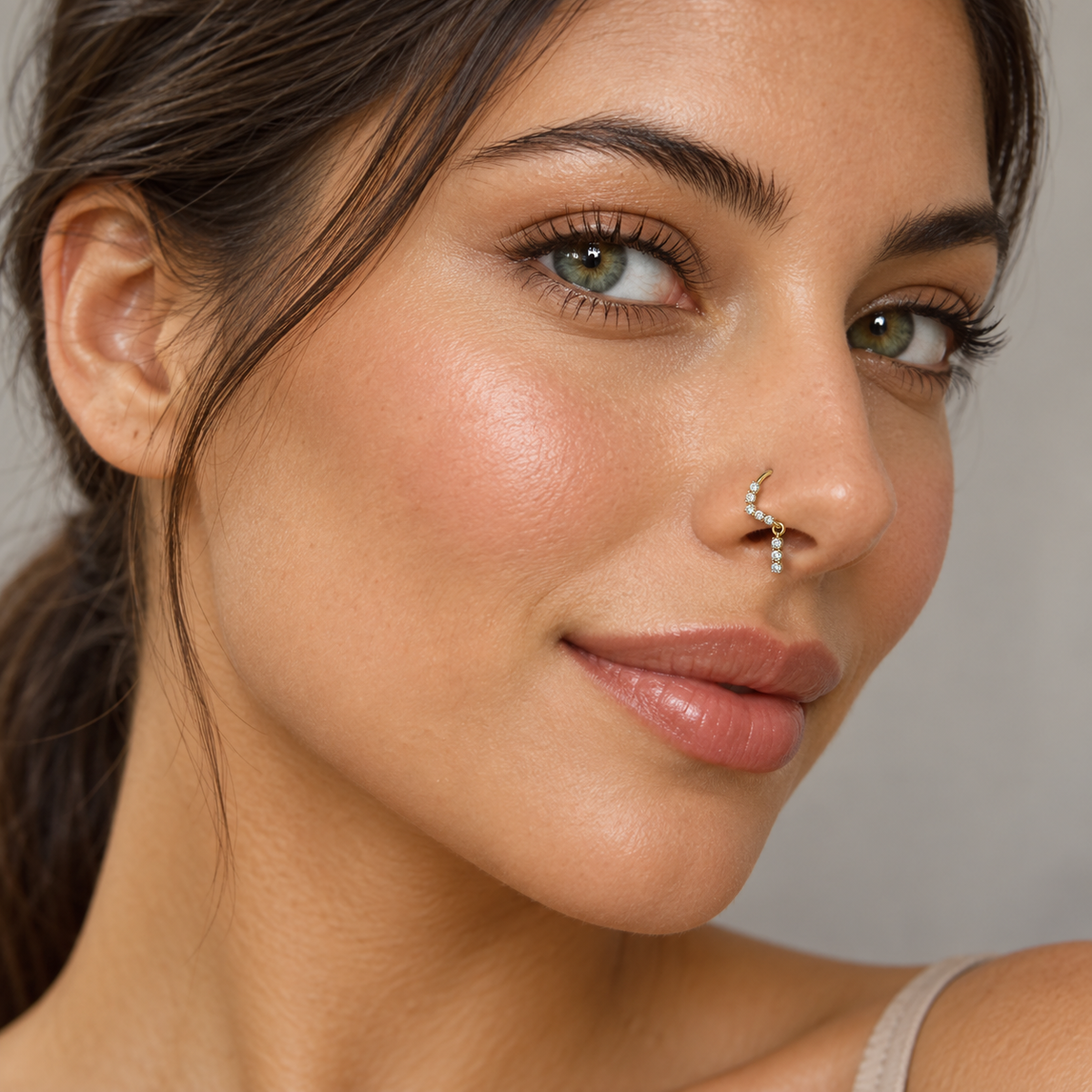 Model wearing gold 118 three-three crystal drop hoop nose ring