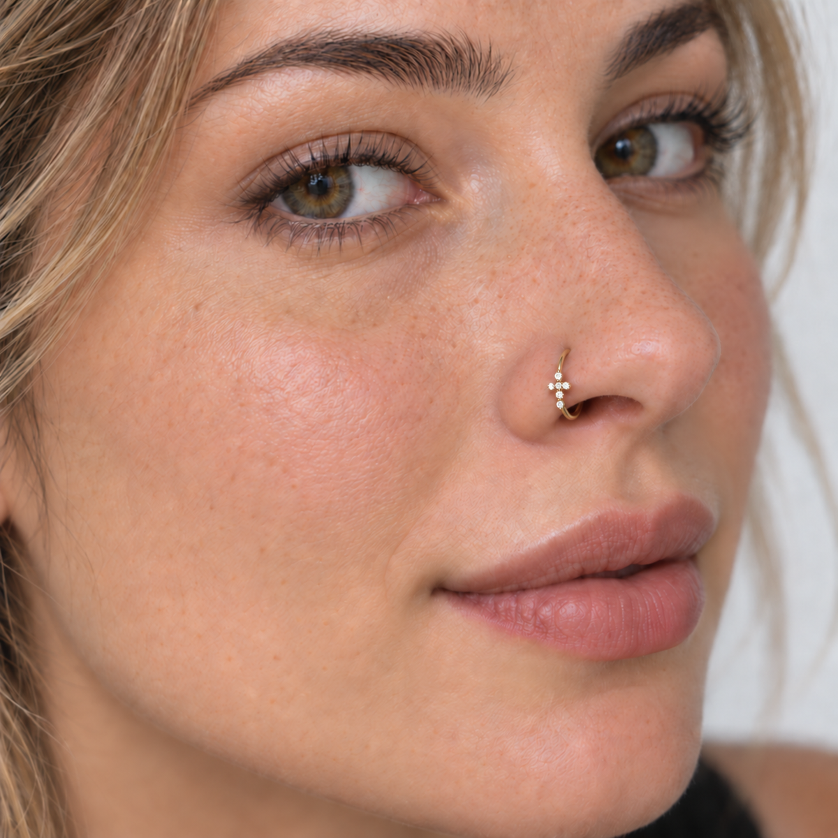 41 petite six crystal cross hoop nose ring worn naturally on nose