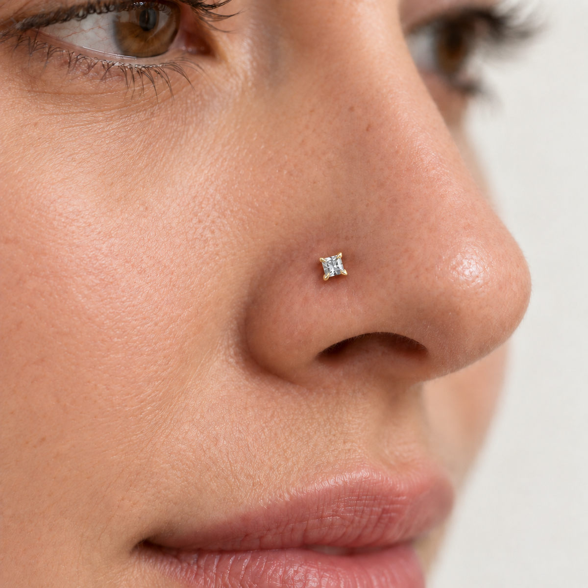 Model wearing JOAJOA 02NL square crystal L-shaped nose stud with delicate hook prongs