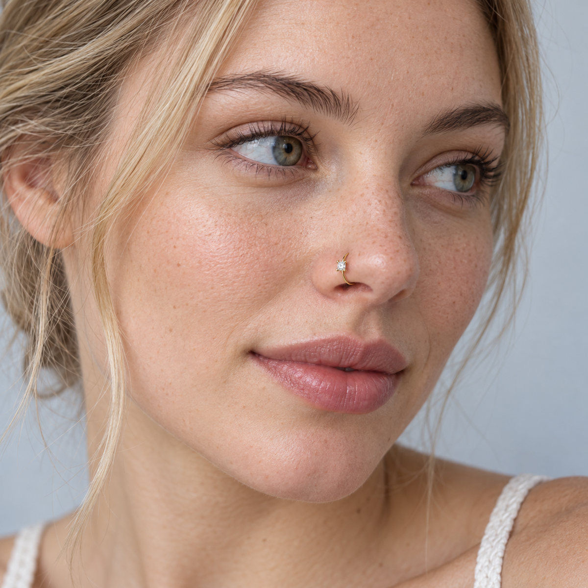 Model wearing JOAJOA 09N petite square crystal gold hoop nose ring