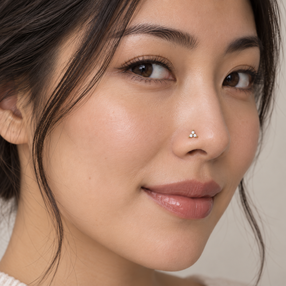 10LC clear three-stone L-shaped nose stud worn on model, corrected scale