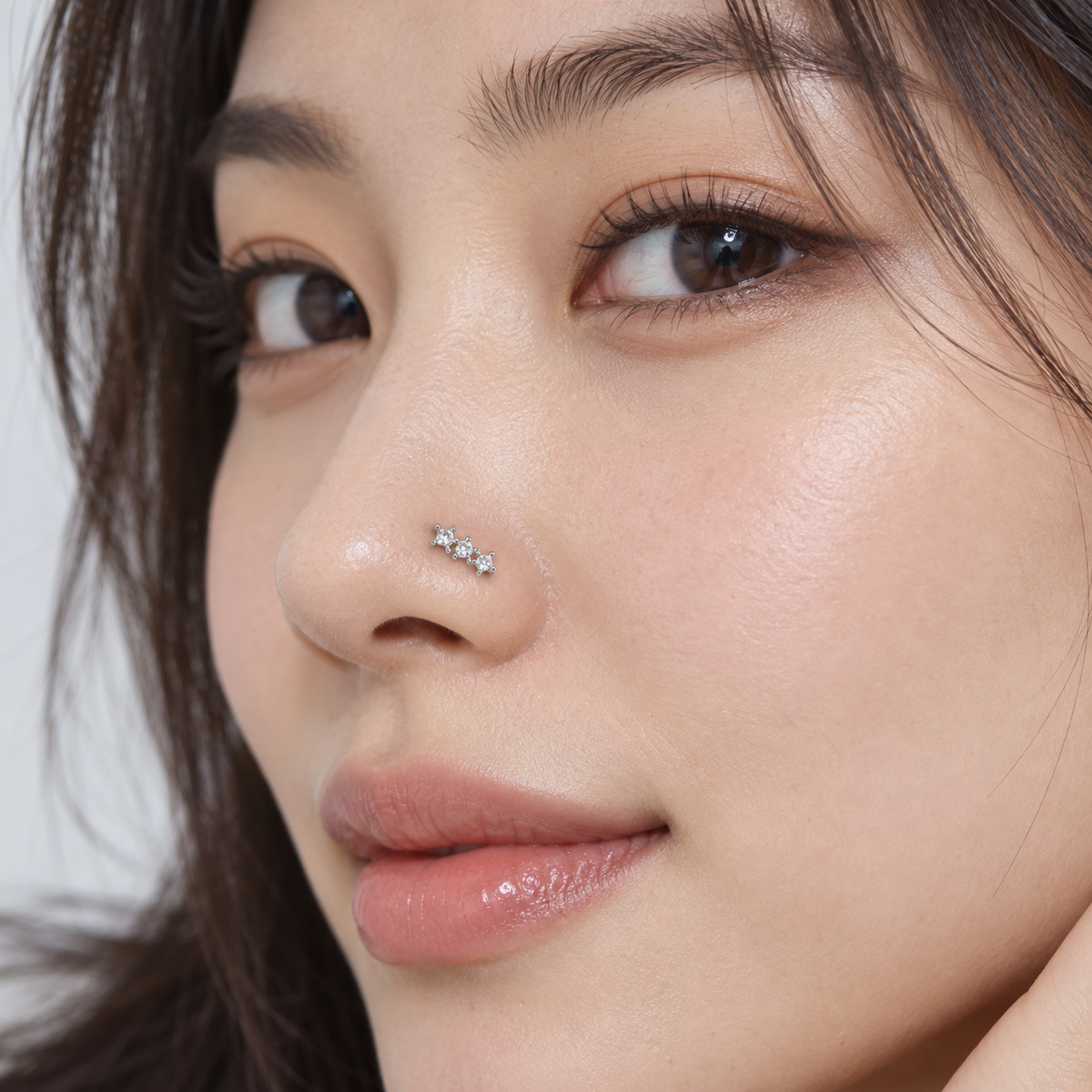 126L Three Star Silver L-Shape Nose Stud worn on model