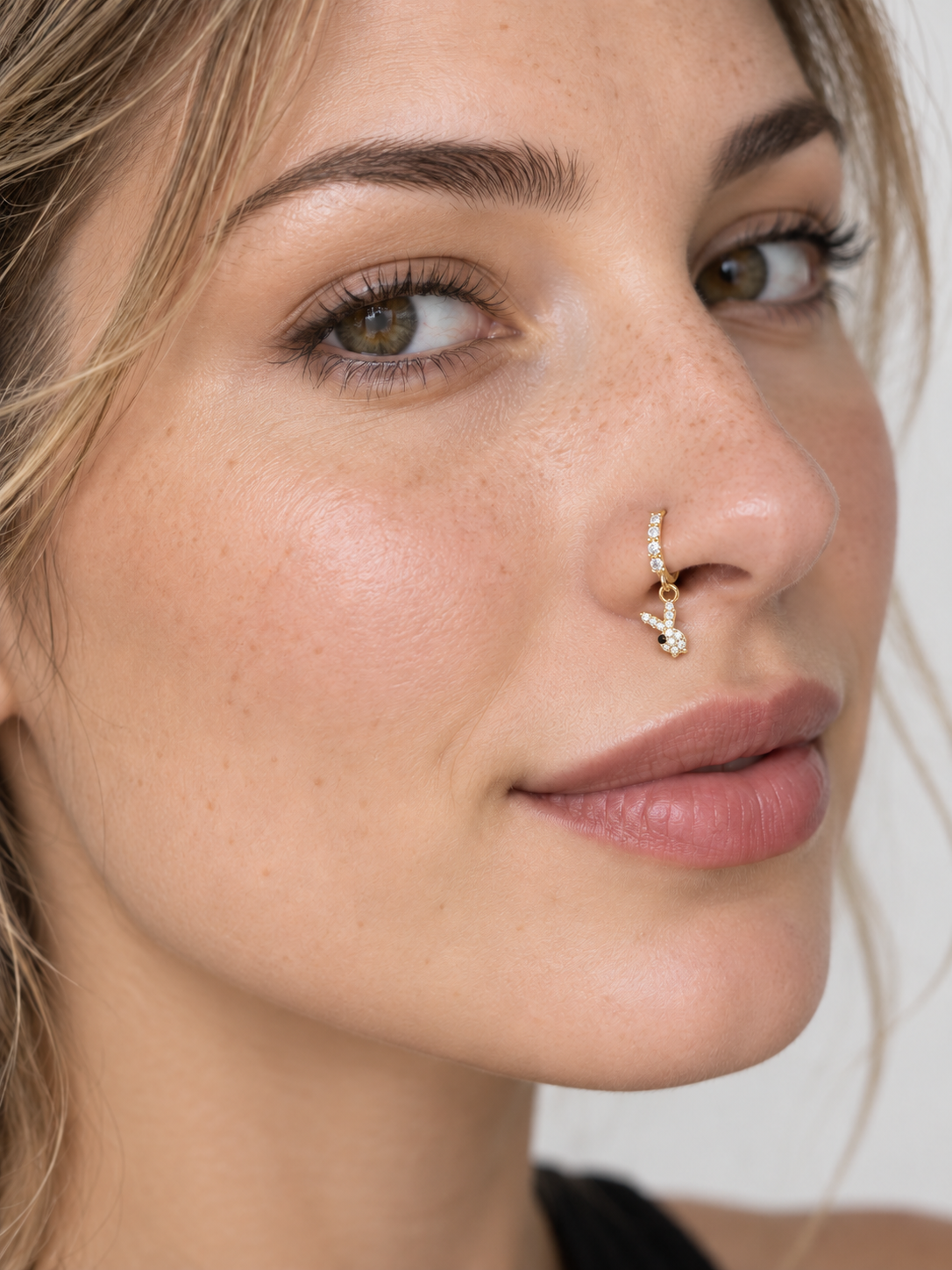 Model wearing JOAJOA 136 crystal rabbit hoop nose ring in gold