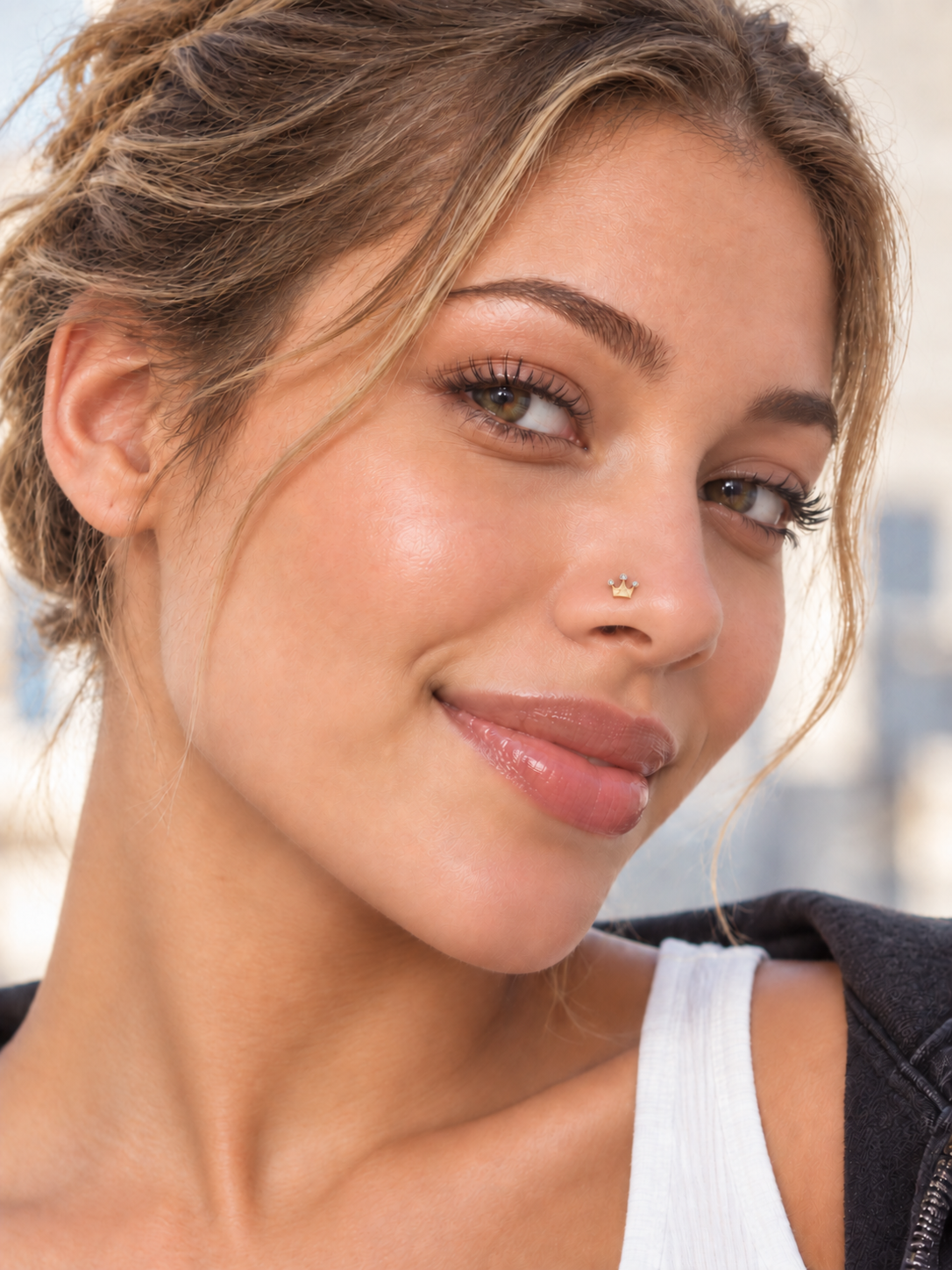 43 gold crystal crown nose stud worn by a young woman