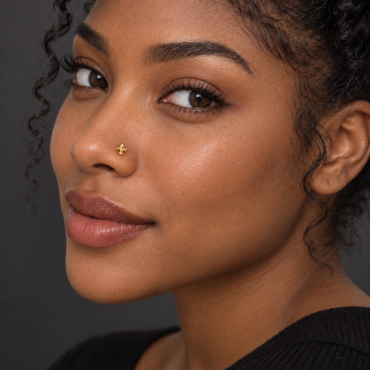 46 petite gold fleur-de-lis ball-tip nose stud worn by Black model