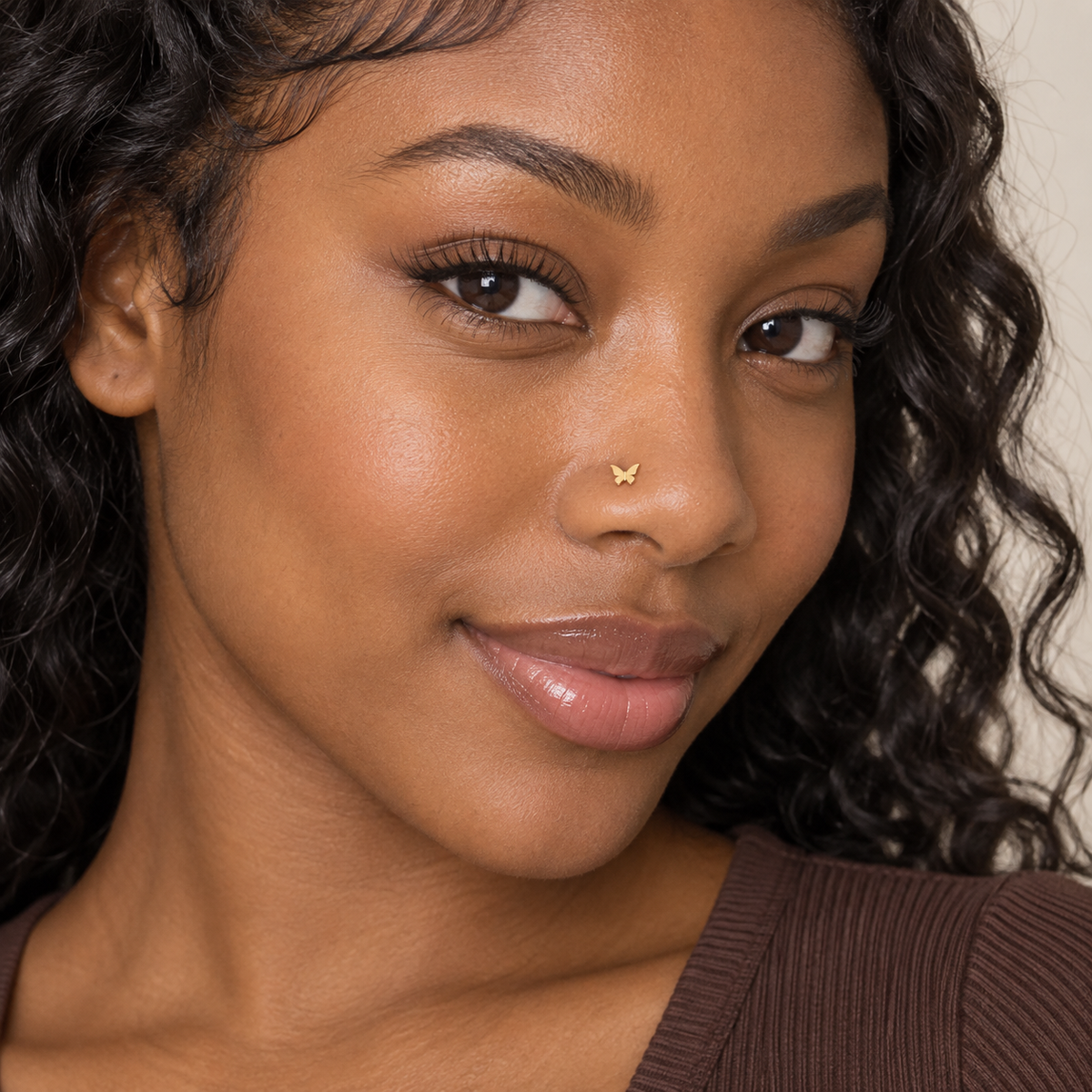 55 dainty gold butterfly ball-tip nose stud worn by model