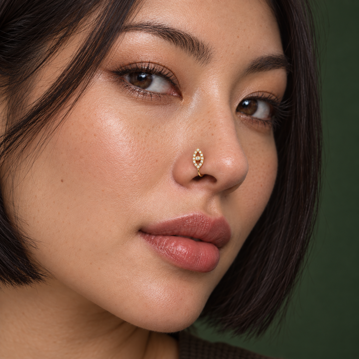 64 petite gold crystal evil-eye clip-on nose ring worn by East Asian model