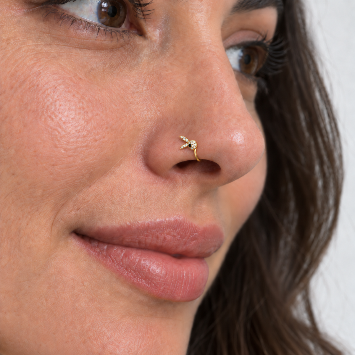 Model wearing tiny exact JOAJOA 65 sideways crystal rabbit clip-on with correct inward curve