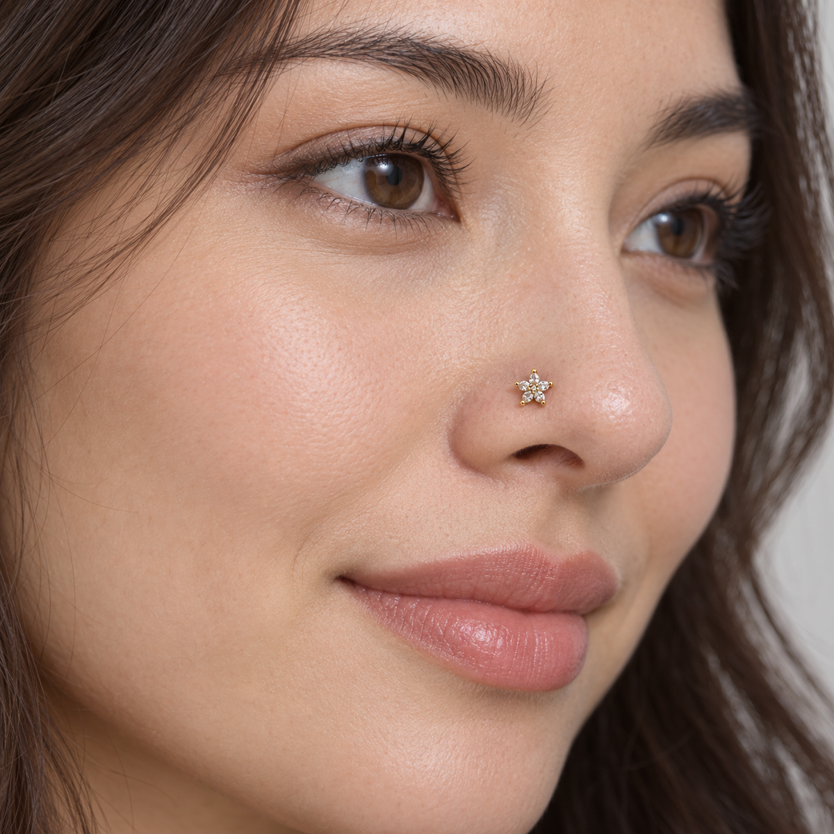 Model wearing JOAJOA 79 petite gold five-petal crystal flower L-shape nose stud