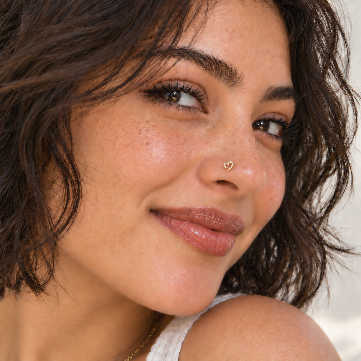 32 gold crystal open heart L-shaped nose stud worn on model