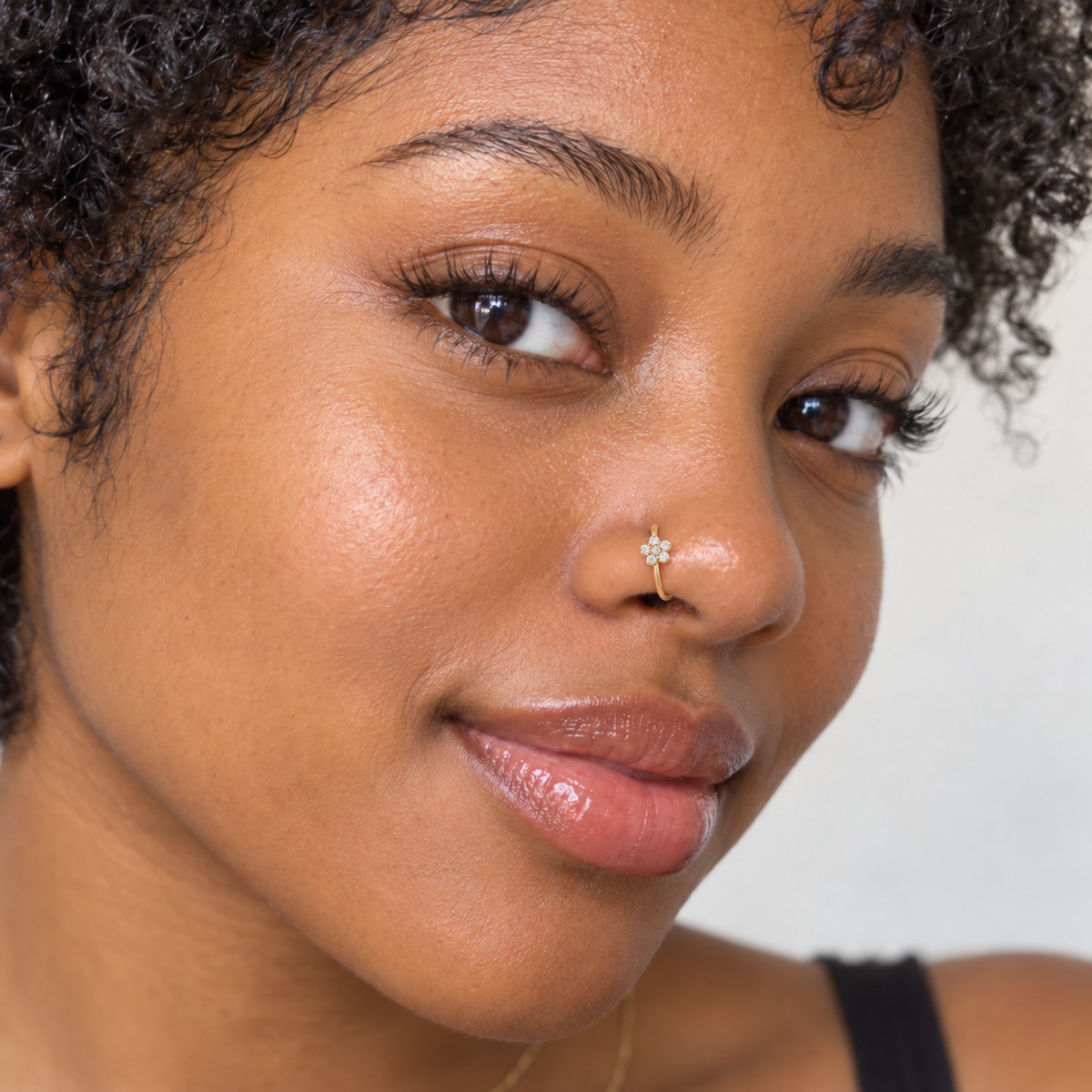 34 gold Tiffany flower hoop nose ring worn on model