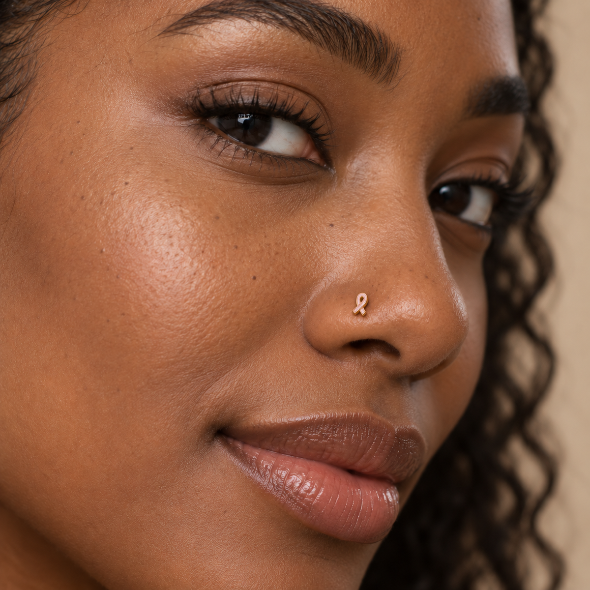 Model wearing JOAJOA 61 petite gold and pink ribbon ball-tip nose stud