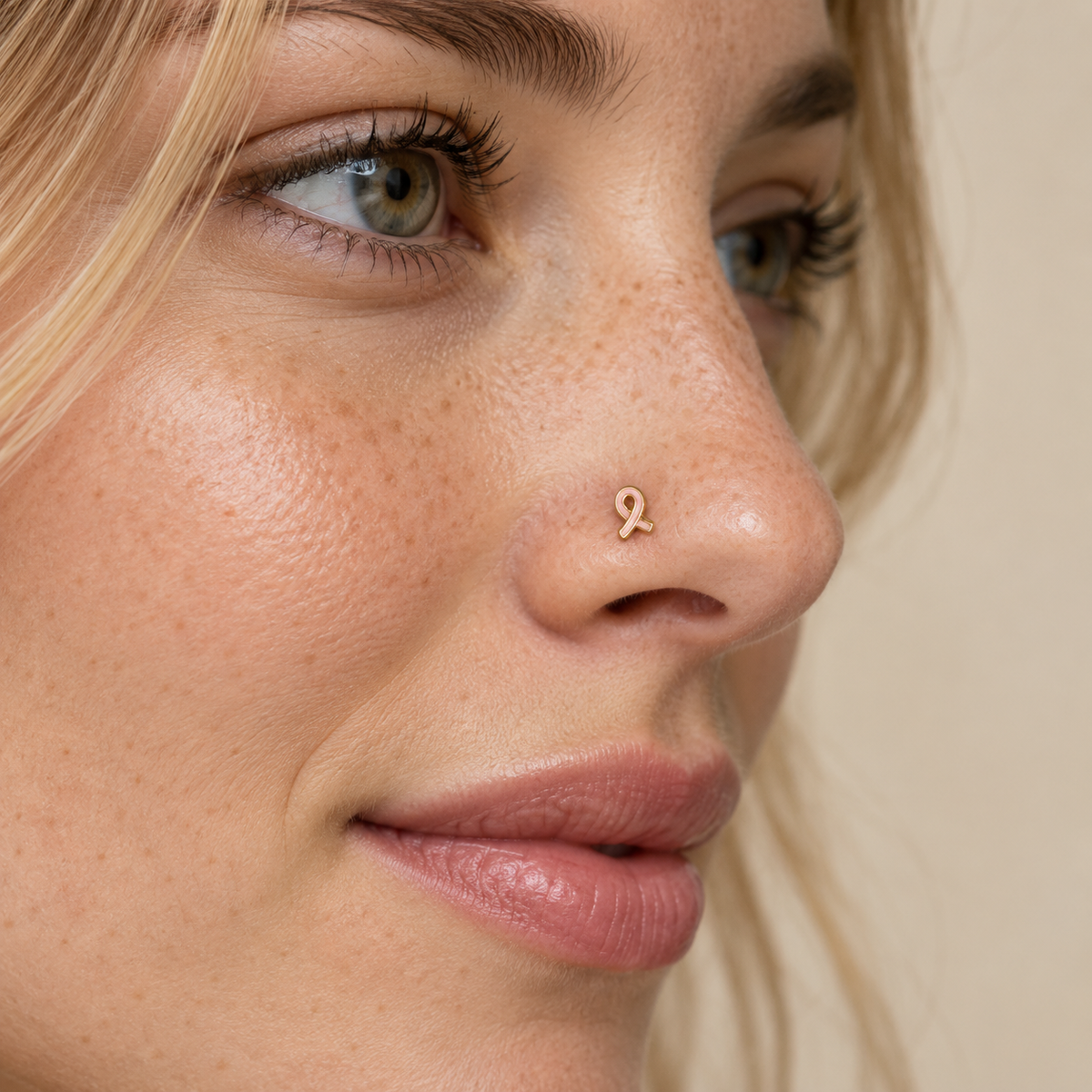 Model wearing JOAJOA 61L gold and pink ribbon L-shaped nose stud