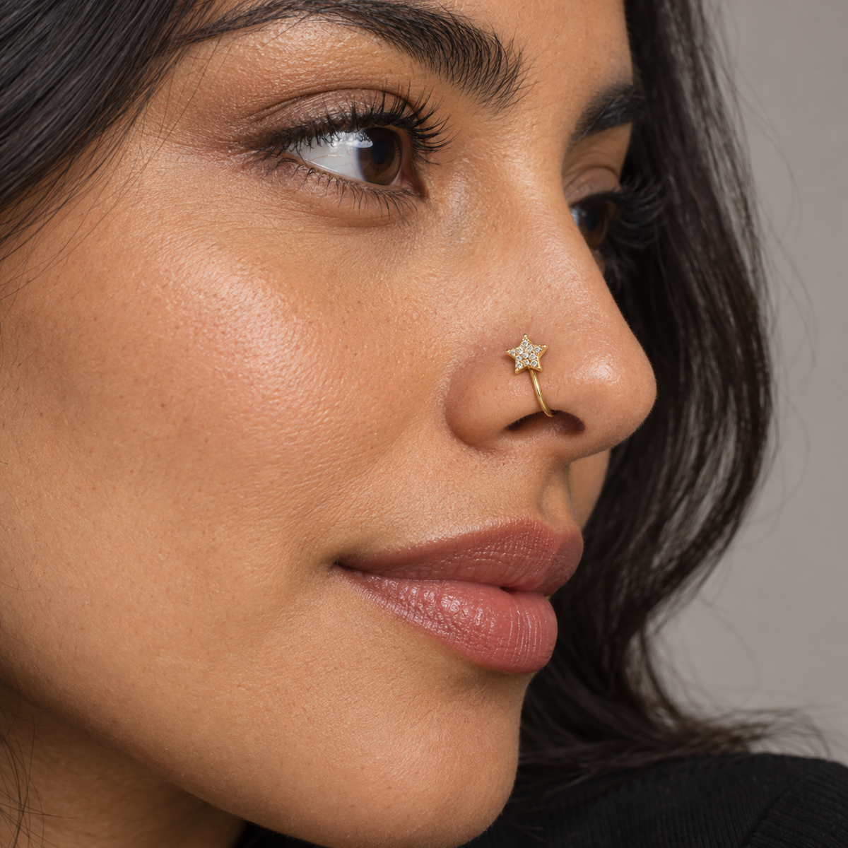 Model wearing JOAJOA 63 gold crystal star clip-on nose ring